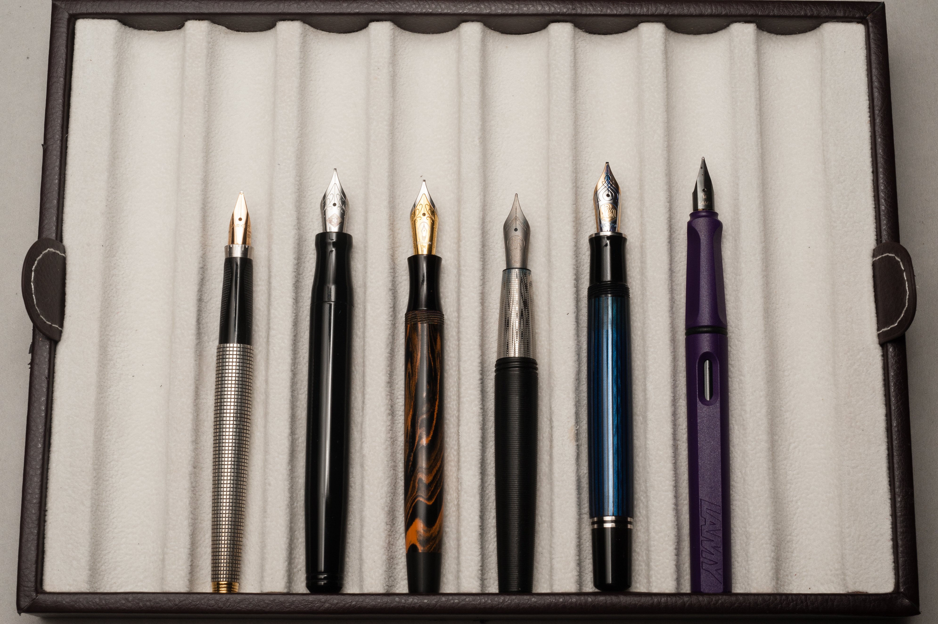 Unposted pens from left to right: Parker 75, Franklin-Christoph Model 20, Edison Beaumont, Tactile Turn Gist, Pelikan M805, and Lamy Safari