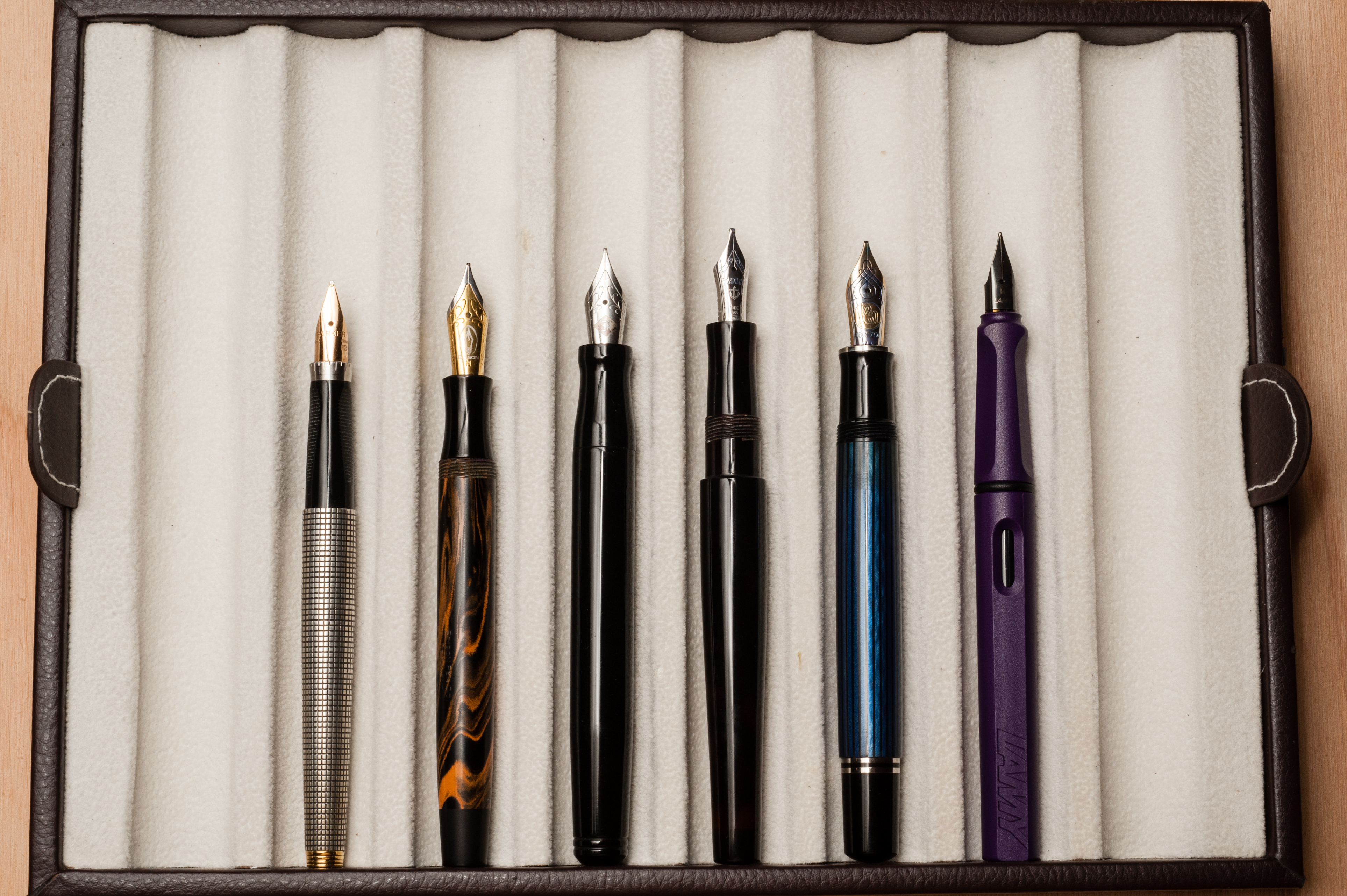 Unposted pens from left to right: Parker 75, Edison Beaumont, Franklin-Christoph Model 20, Newton Townsend Slim Short, Pelikan M805, and Lamy Safari
