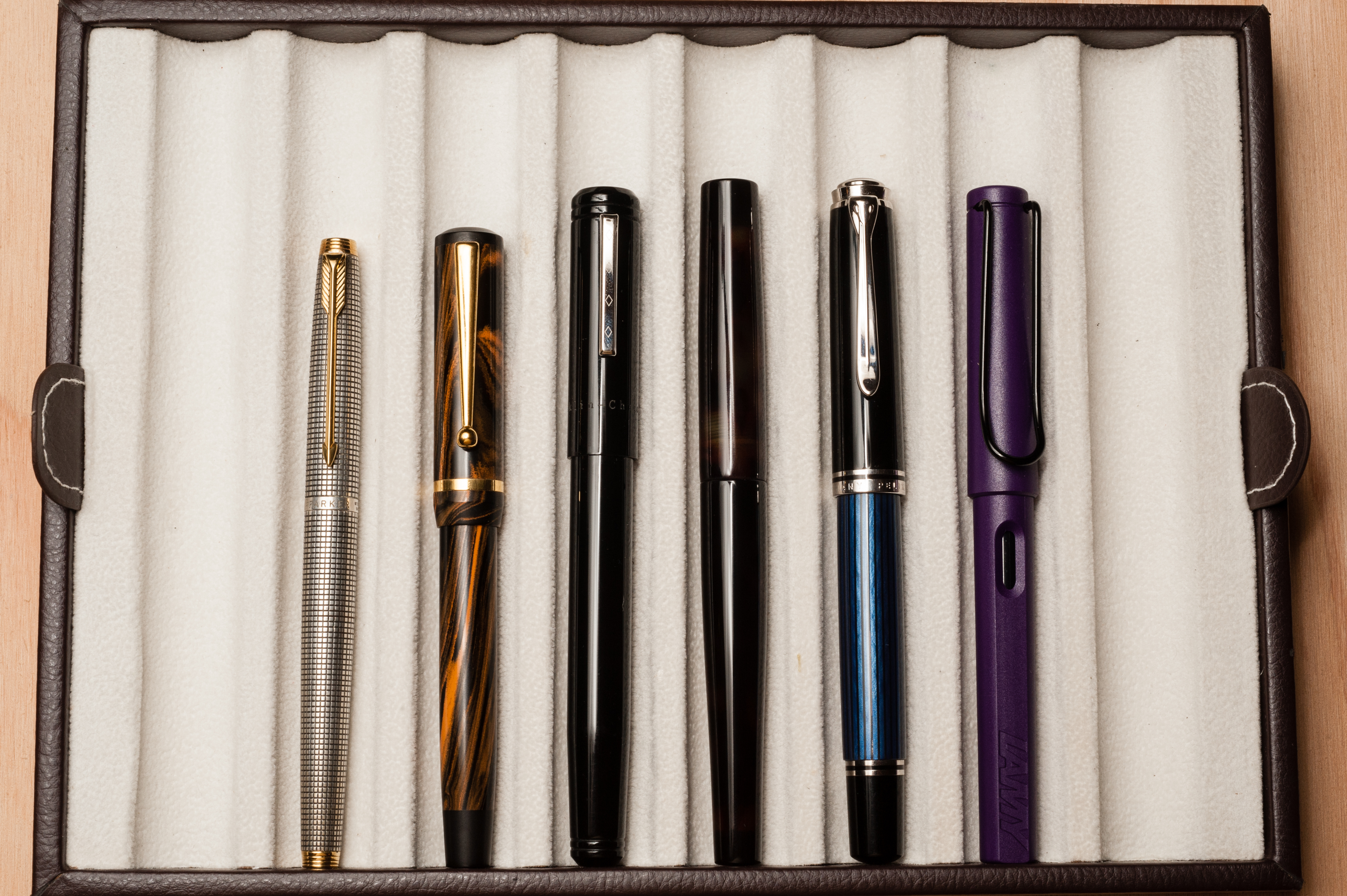 Closed pens from left to right: Parker 75, Edison Beaumont, Franklin-Christoph Model 20, Newton Townsend Slim Short, Pelikan M805, and Lamy Safari